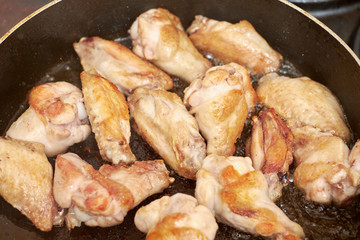 Chicken wings fried in pan with hot oil, homemade food