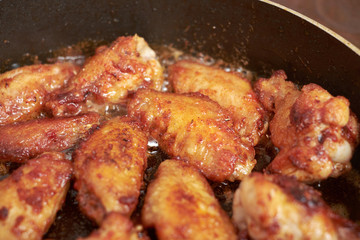 Chicken wings fried in pan with hot oil, homemade food