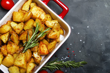 Baked potatoes with spices and rosemary, top view