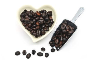 Top view of coffee bean in heart shape and scoop for valentine festival isolated on white background