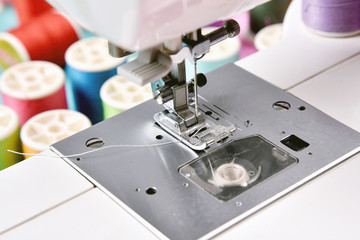 Pastel color, Dressmaker and designer desk, Close up foot of sewing machine and handcraft accessories.