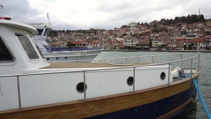 Boats in harbour against old town of Ohrid, Macedonia