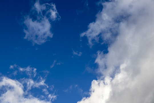 White springtime cloudscape on a solid blue sky