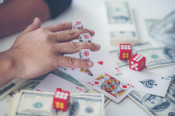Close up of businessman throwing dice. Gambling concept