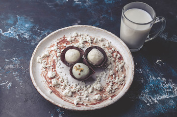 Handmade chocolates with cheese stuffing on a dark background. white milk chocolate. clouse up