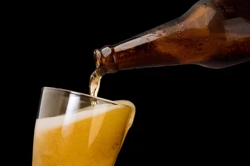 Tragetasche Pouring beer into mug or glass isolated on black background object alcohol celebration concept © Love the wind