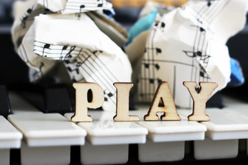 Piano keys closeup with the letters play