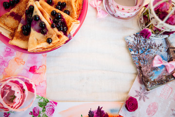 Breakfast: pancakes with blueberry berries, currants on a pink plate in the style of Provence.. dessert