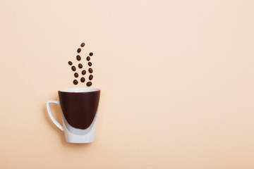 coffee beans and a cup on a light background