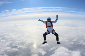 Skydiver is flying in the winter sky.