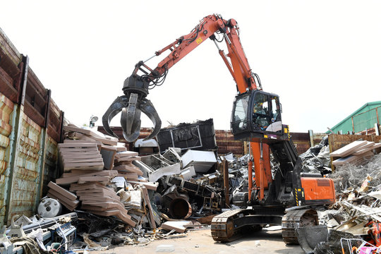 Excavator is loading scrap Industrial waste.
