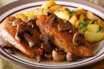Chicken Marsala with garnish of potatoes macro. horizontal