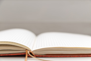 Open blank notepad on white background close-up