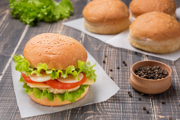 ready burger with turkey, a few buns and spices on old boards