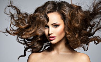 Face of a beautiful  woman with long flying   hair