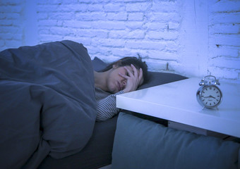 young beautiful sad and worried latin woman suffering insomnia and sleeping disorder problem unable...