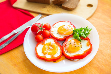 Fried eggs in red peppers