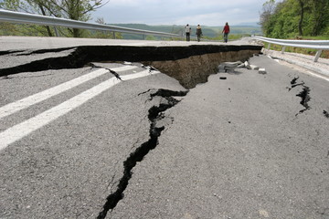 Road collapses with huge cracks. International road collapsed down after bad construction. Damaged Highway Road. Asphalt road collapsed and fallen. Erosion. 
