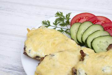 steak with vegetables on a white wooden background