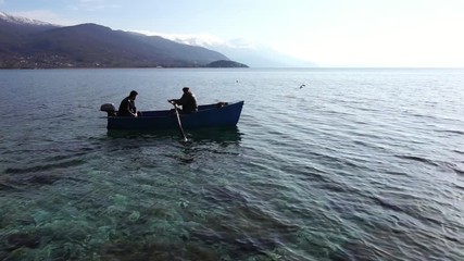 Two men paddling boat in Ohrid Lake, Macedonia