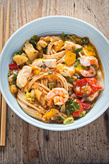 Spicy chicken & king prawn with wholewheat noodles. Strips of cooked chicken breast and king prawn with wholewheat noodles coated in chilli, lime and coriander sauce with vegetables. 