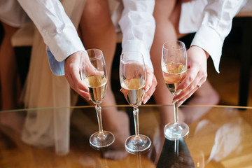 The bride and her girlfriend are celebrating the morning of the marriage