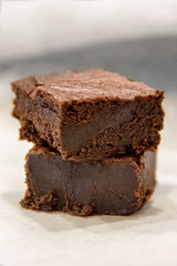Fototapeta na wymiar Stack of two dark chocolate chewy brownies