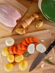 fresh peeled vegetables, potatoes, carrots and onions on the cutting Board