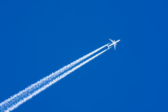 White aircraft big two engines aviation airport contrail clouds.