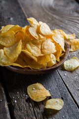 Potato chips on a wooden table