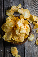 Potato chips on a wooden table