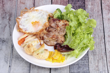 Chicken steak and grilled mixed vegetables .