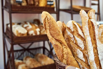 Wall murals Bakery Bread baguettes in basket at baking shop
