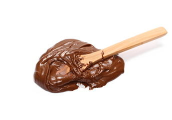 Cream chocolate spreading and wooden spoon isolated on white background