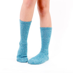 Blue cotton socks on beautiful woman's feet. Isolated on white background. Studio lighting