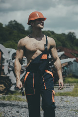 Man, builder or bodybuilder with strict face in hard hat.