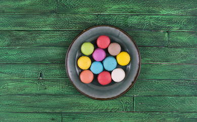 colorful french macarons ,green wooden table