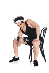 Fototapeta na wymiar Young thin sportsman exercising with dumbbell while sitting on chair isolated on white