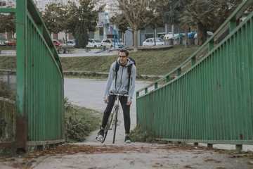 young man cycling around the city doing sport