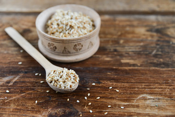 white sesame seed, sesame seed in wooden Cup on natural wooden background in rustic style