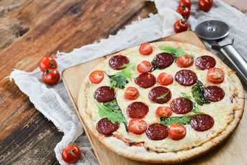 Tasty Pizza With Tomato Sauce, Pepperoni Sausage, And Mushrooms On Wooden Background Natural Rustic, A Pizza Cutter And Ingridienty.