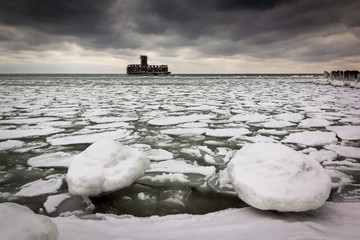 Frozen Baltic sea and ruins old military building in Babie Doly, Gdynia, Poland