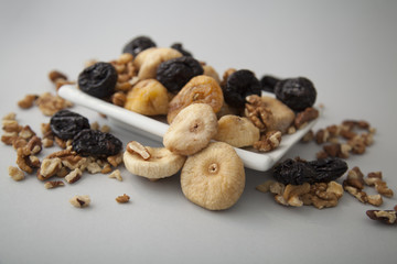 dryed figs and plums with nuts on white isolated background