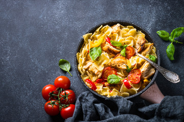 Pasta with chicken and vegetables top view.
