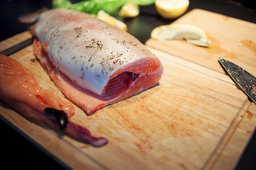 process of cutting fish on a wooden Board
