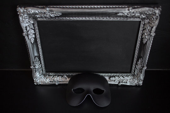 arnival mask and beautiful silver frame baguette with empty place for your text or design.
