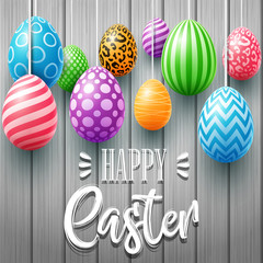 Colorful easter eggs decorated on a wooden background