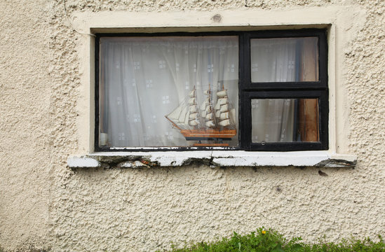 A model boat in the window of an old Irish house