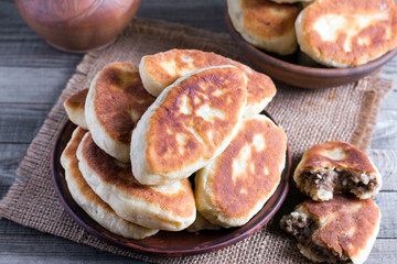 Fried patties with the meat in the plate on wooden table