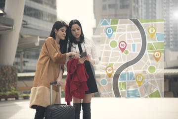 young woman tourist using gps map in a smart phone in the city background.